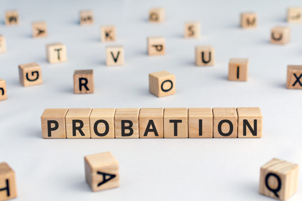 probation - word from wooden blocks with letters, time criminal is allowed to stay out of prison or period a new employee is suitable for work concept, random letters around, white background