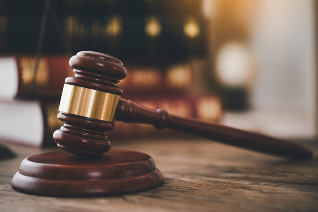 Law theme, mallet of the judge, law enforcement officers, evidence-based cases, and documents taken into account.