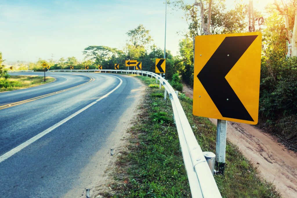 Curve warning sign on a Colorado road marking a no-passing zone
